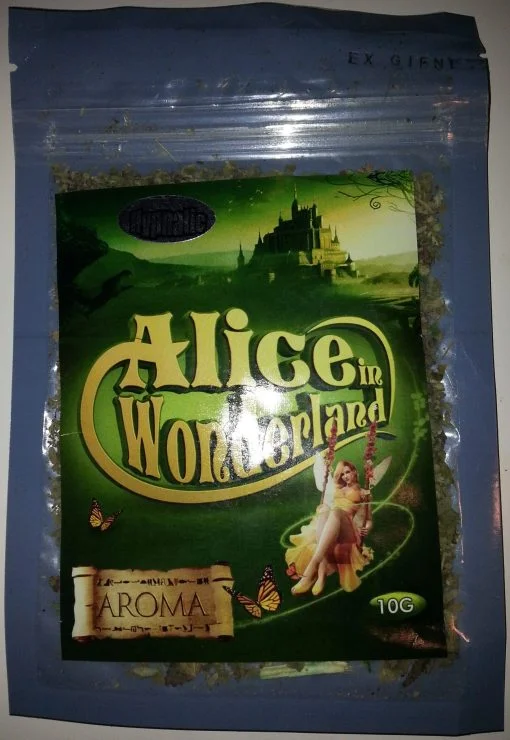 Alice In Wonderland Herbal Incense burning in a decorative holder, with fragrant smoke curling upward, creating a magical atmosphere