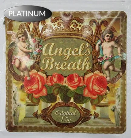 Angels Breath Herbal Incense burning in a decorative holder, with gentle wisps of aromatic smoke rising into the air