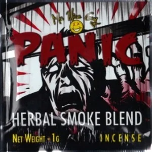 A stick of Panic Herbal Incense burning, releasing strong, aromatic smoke in a vibrant setting